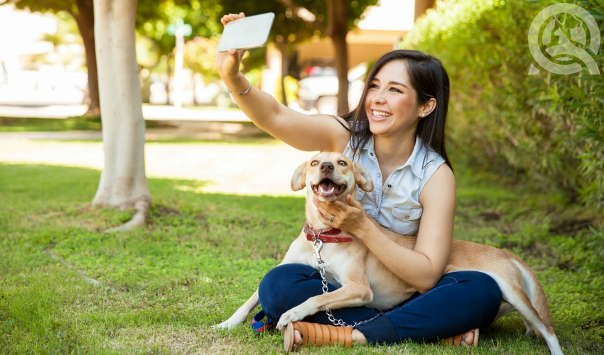 girl taking selfie with dog