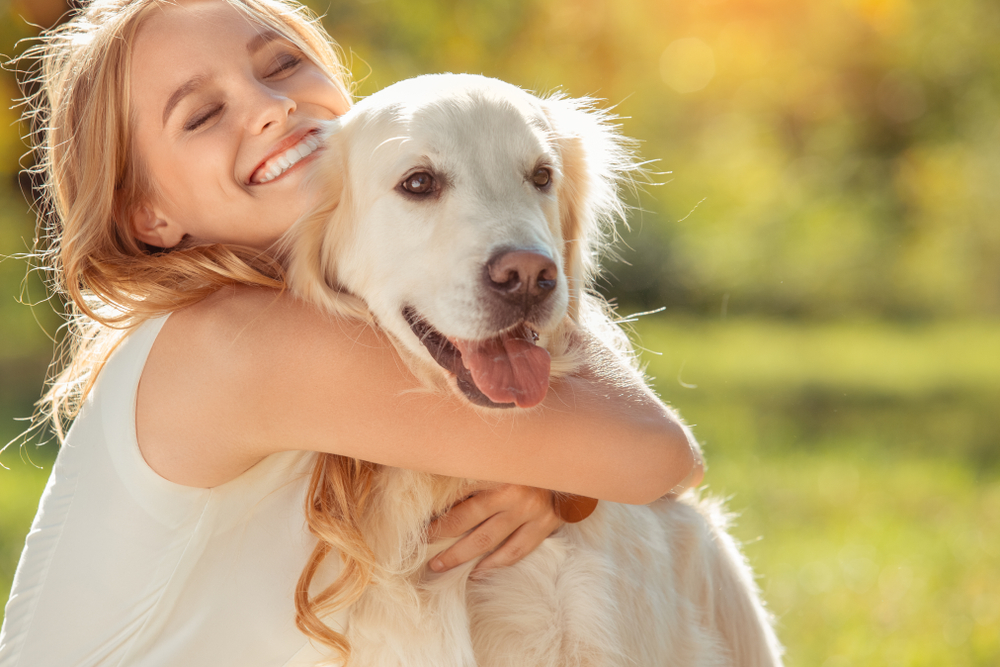 new pet owner hugging large dog