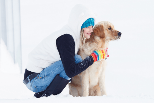 dog grooming license woman outside in the snow with her dog